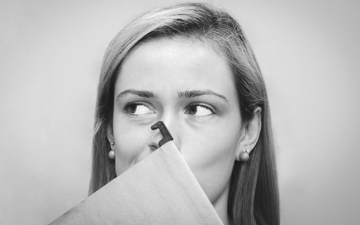 Woman holding a tissue near her nose
